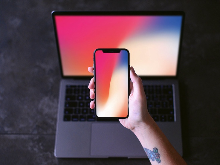 iPhone-X-in-Hand-with-Macbook-Mockup